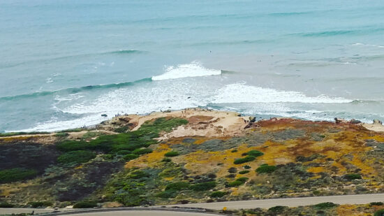 View of surf at Point Loma CA, a San Diego neighborhood with tidepools and a lighthouse