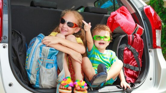 Road trip planner - get the kids involved. in the back of a large vehicle.
