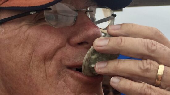 Man slurps an oyster in Gulf Shores Alabama