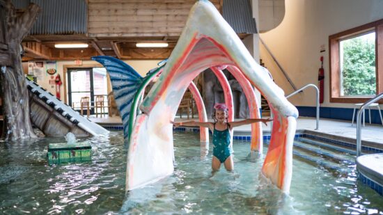 Child playing in water structure at Rapid River Lodge, one of the best indoor water parks in Minnesota